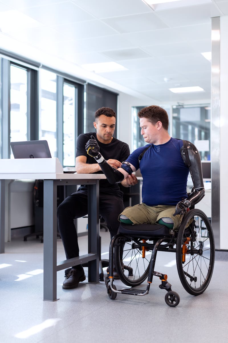 Engineer Fitting Prosthetic Arm